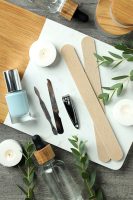 concept-of-nail-care-with-manicure-accessories-on-wooden-background